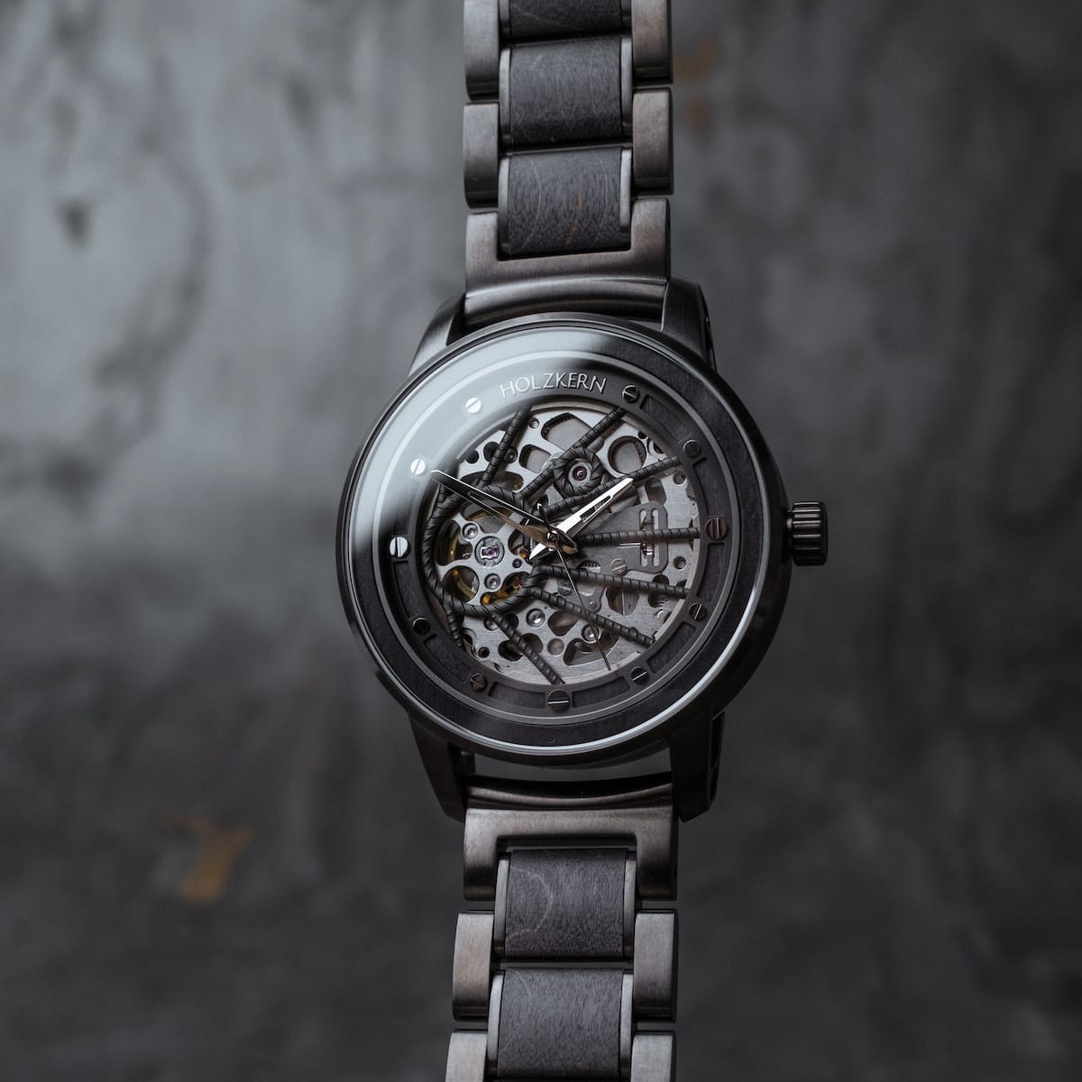 "Carbon" watch, featuring a gray maple and dark gray style, showcases a sleek, modern design with intricate detailing.