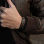 "Tremolo", a stylish bracelet with zebrawood and black accents, shown on a person's wrist.