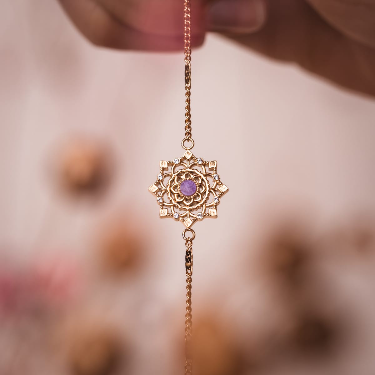 "Aphonia Bracelet", a delicate amethyst and gold bracelet, featuring an intricate mandala design.
