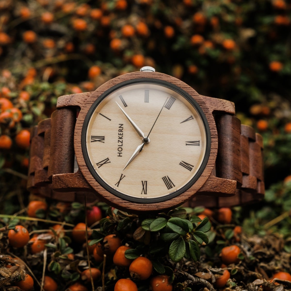 "Fall Dusk", wooden watch in walnut and maple with a classic analogue face amidst vibrant autumn foliage.