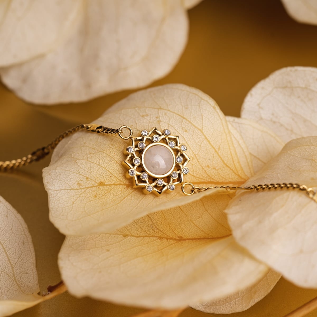 "Composition Gem Bracelet" bracelet featuring moonstone and gold with an elegant and intricate design.