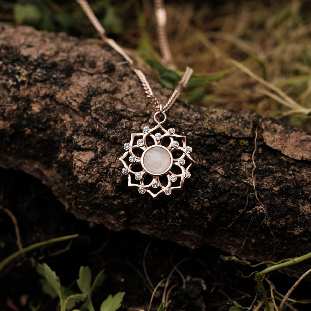 "Composition Gem Necklace": Elegant necklace featuring a moonstone pendant with a rose gold finish in a natural setting.