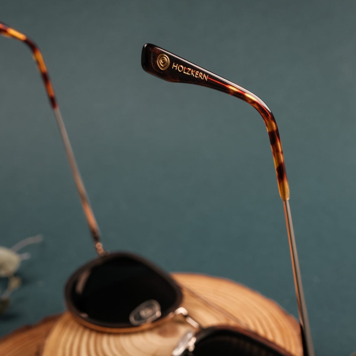 "The Risky" sunglasses feature a stylish design with zebrawood and matte gold accents.