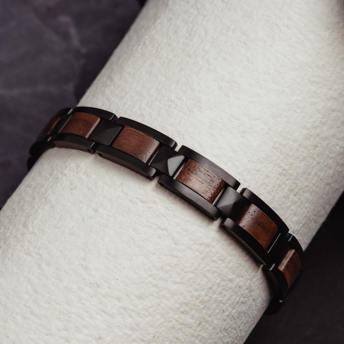 "Rhapsody" bracelet featuring a sleek walnut and black design, offering a modern and elegant style.