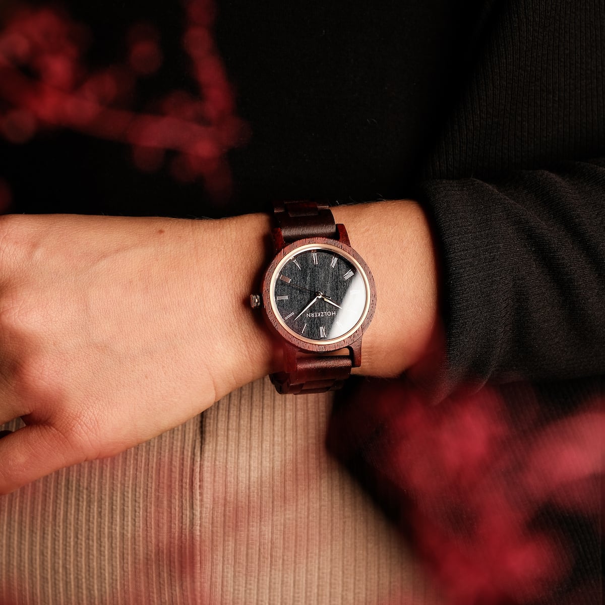 "Passion", a sleek wristwatch crafted from Padauk and Maple, features a sophisticated design on a wrist.