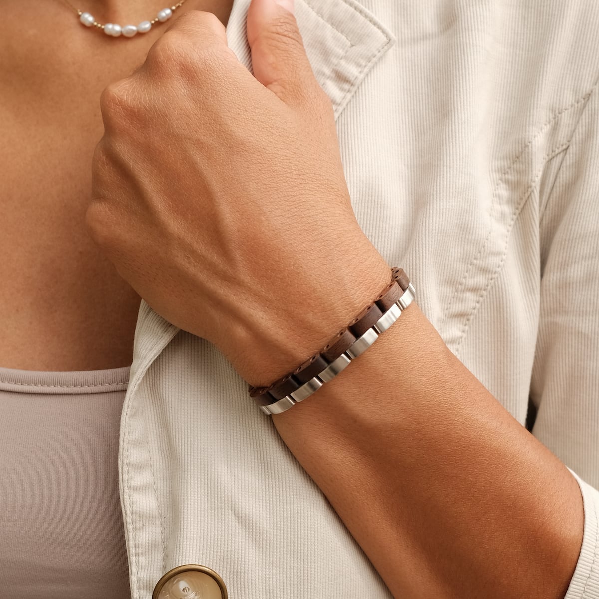 "Duet" bracelet featuring a walnut and silver design, worn fashionably on a wrist.