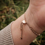 "Leave" bracelet featuring a delicate chain design with a warm walnut finish.