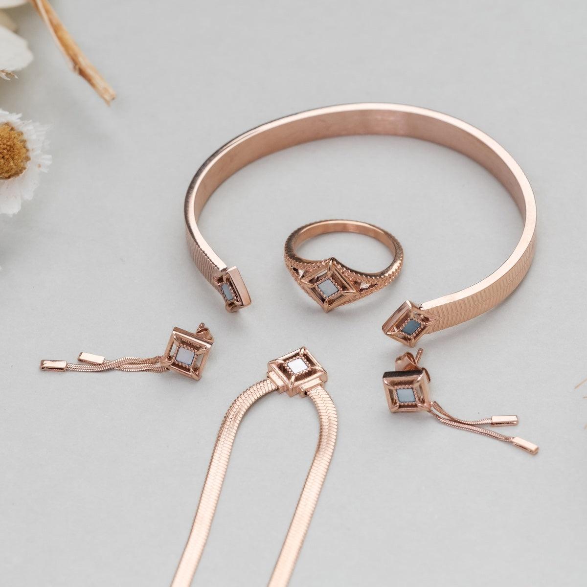 "Awakening Necklace", a rose gold necklace with nacre accents, featuring a sleek, elegant design.