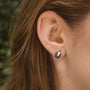 Opacity Earrings showcase a minimalist design with walnut and silver accents.