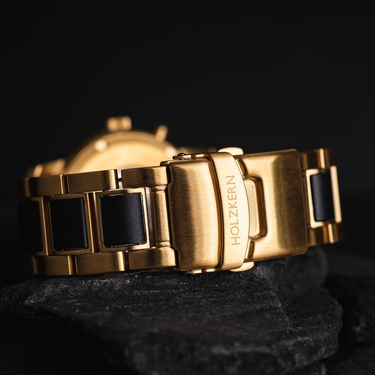 "Cyclonic" watch featuring an elegant maple and marble design with a sleek, gold metallic finish.