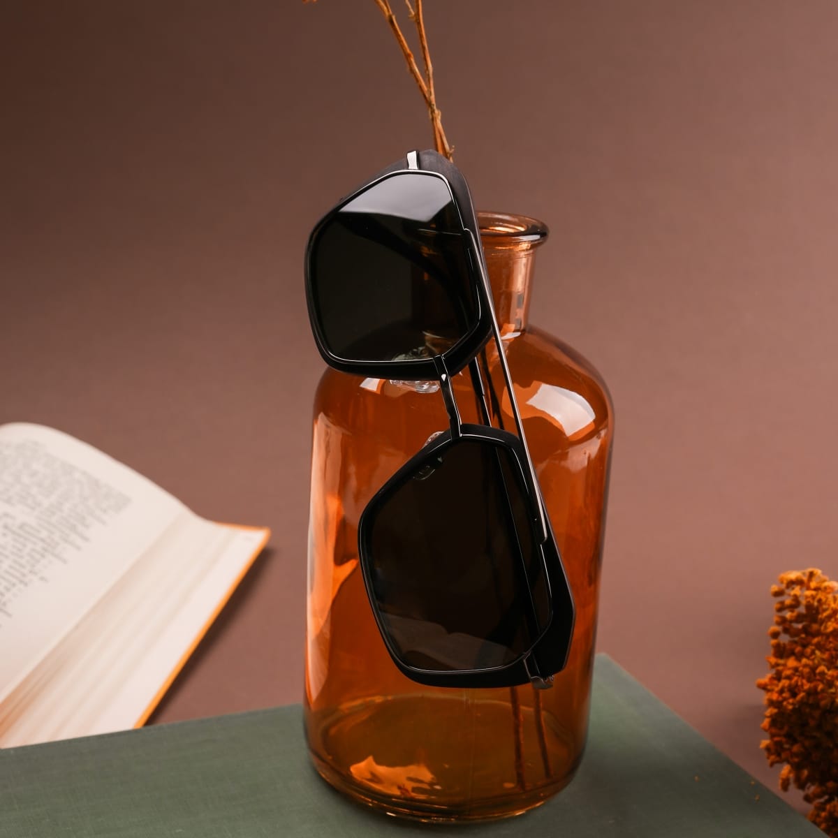 "The Storyteller sunglasses in Leadwood/Antique Silver, featuring a sleek, modern design with dark lenses."