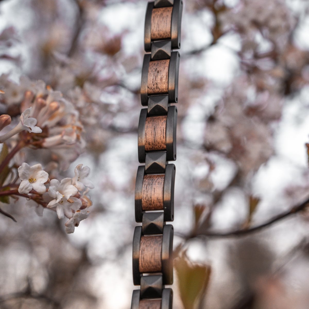 "Rhapsody" bracelet featuring walnut and black accents in a natural setting.