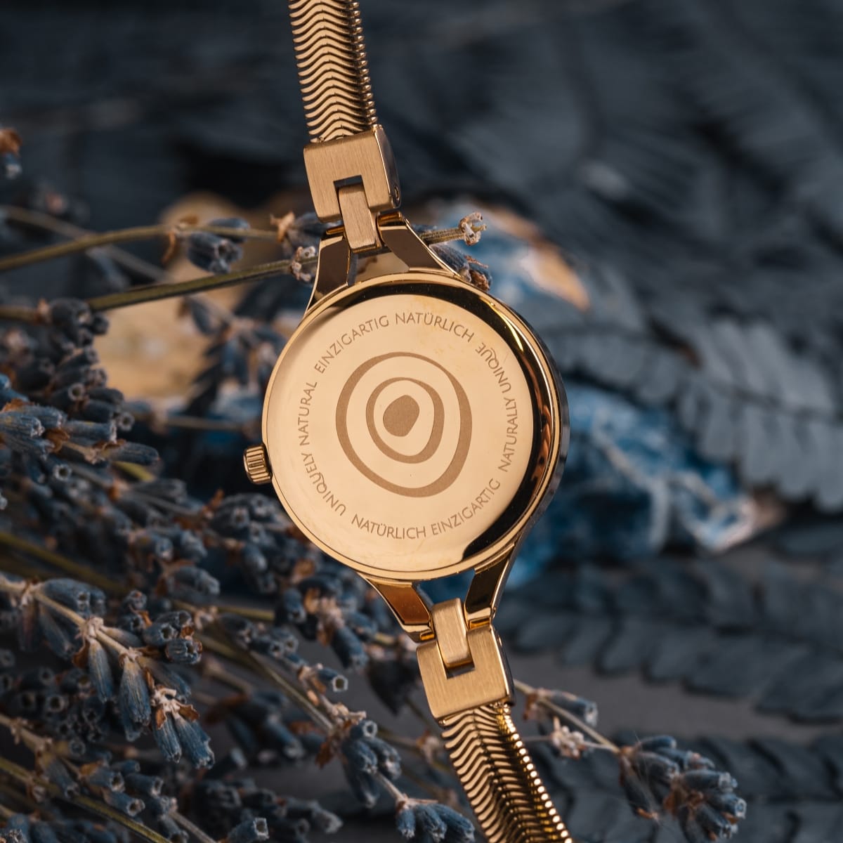 "Kaliya" luxury watch featuring a nacre and gold finish with a natural, elegant design.