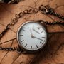 "Touching" watch with nacre dial and antique copper finish on a leaf background.