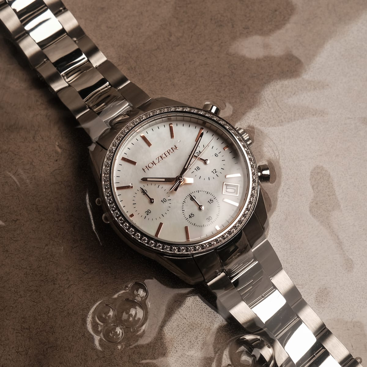 "The Balanced", a luxury watch featuring a nacre dial and silver design with elegant detailing.