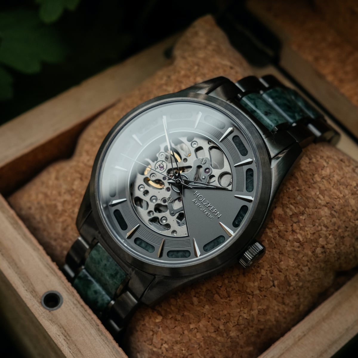 "Acraman" watch featuring a sophisticated marble and dark gray design with a visible mechanism in a wooden box.