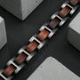 "Acoustic" bracelet featuring walnut and gray elements in a sleek, modern design.