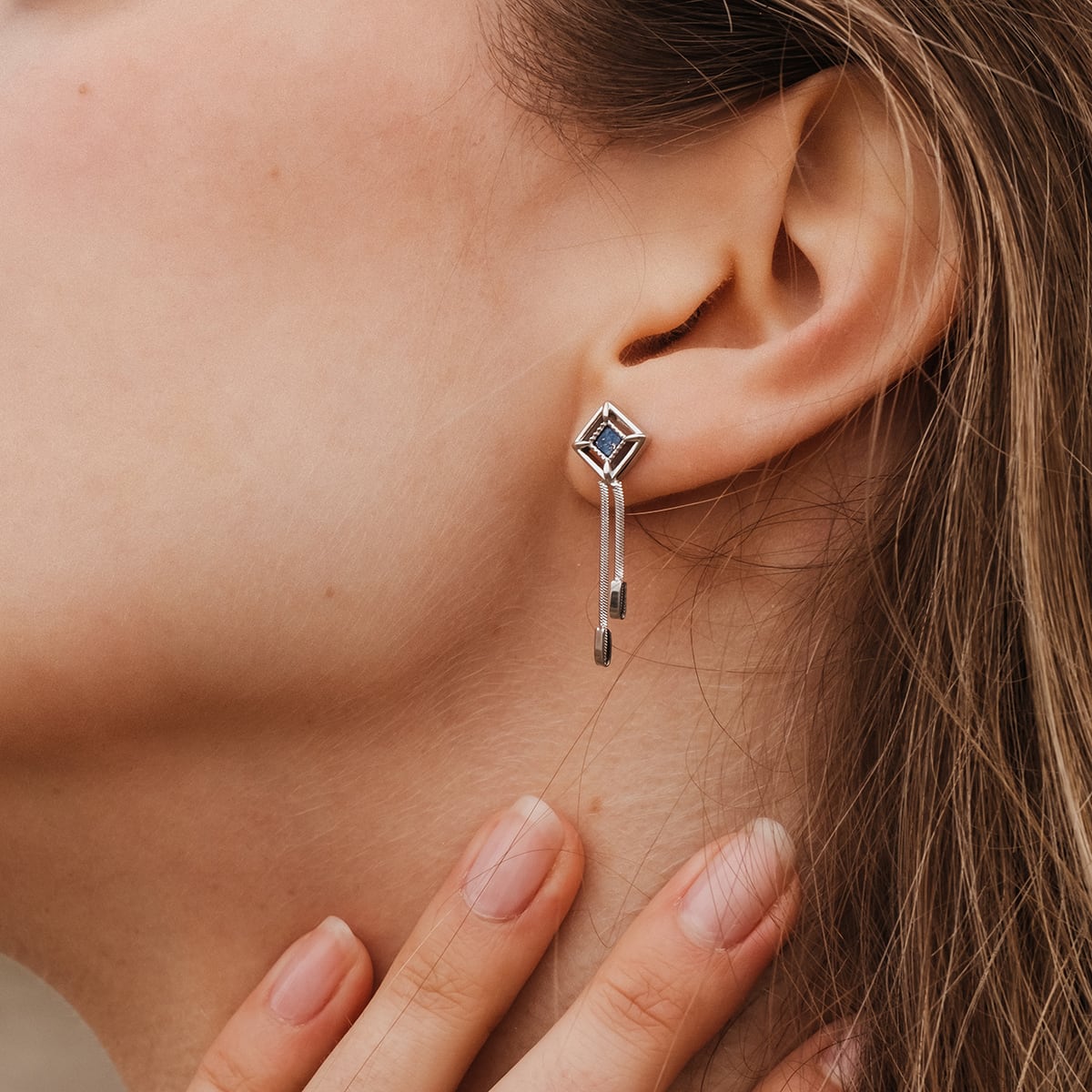 "Awakening Earrings": Elegant earrings featuring lapis lazuli set in silver, with a sleek and modern design.