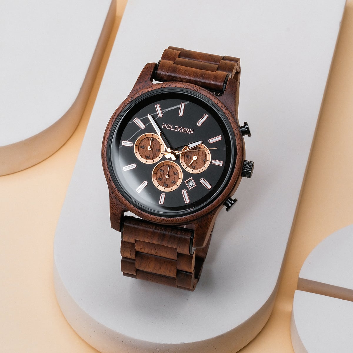 "Thicket", a stylish watch made from Walnut wood and marble, features a sleek design with a dark face and wooden bracelet.