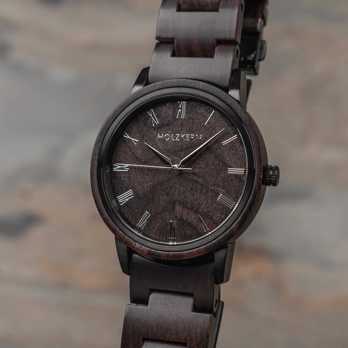 "Carlos" watch with a sleek maple design and minimalist novel numerals on a dark wooden dial.