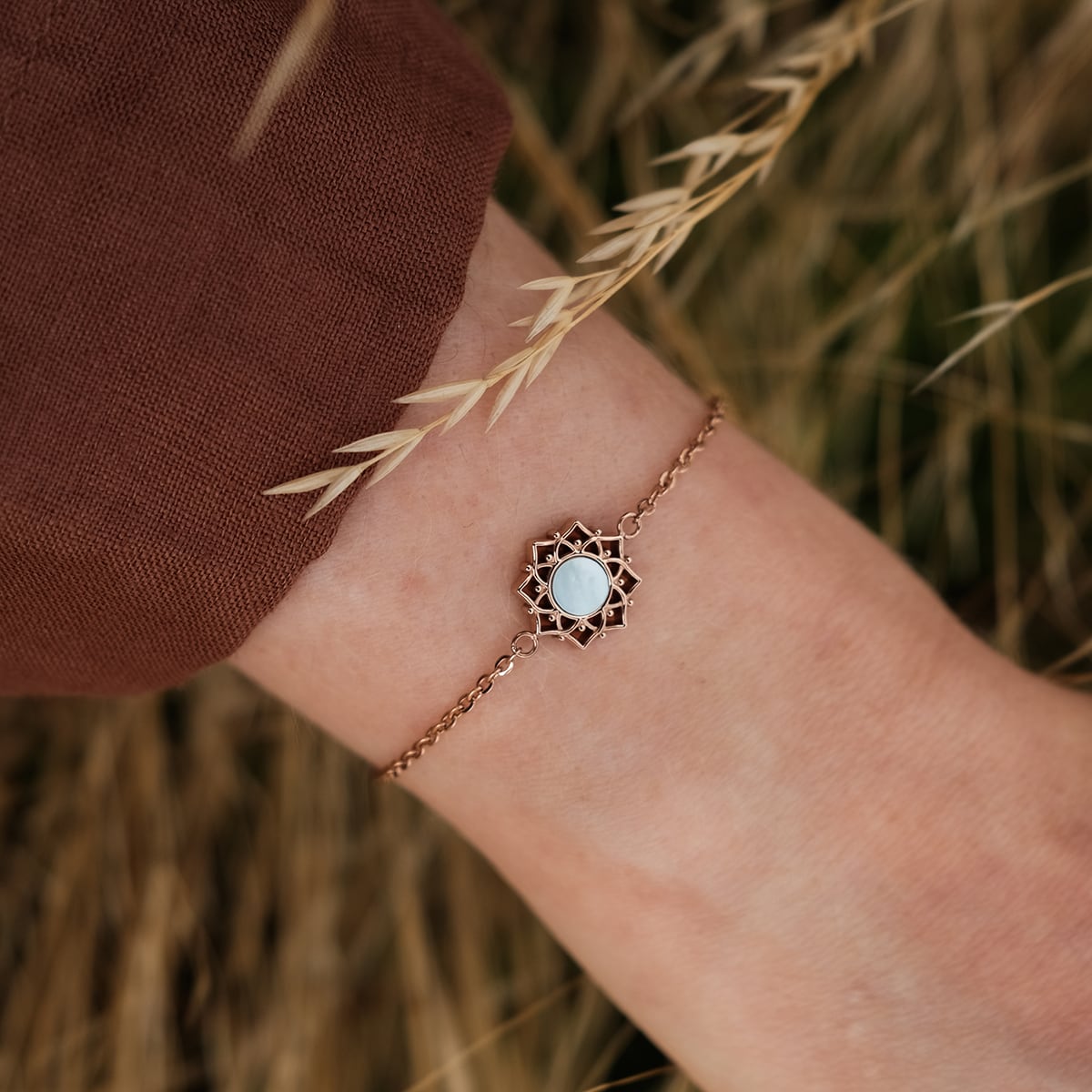 "Composition Bracelet" bracelet, featuring blue nacre and rose gold detailing, styled elegantly on the wrist.