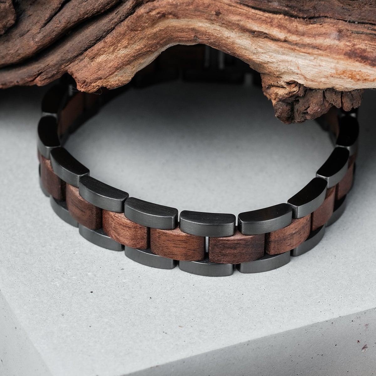 "Triad" bracelet featuring walnut and gray links, with a sleek and modern design.