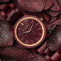 "Calm" watch in Amaranth, featuring an elegant design with wooden elements and a vibrant color scheme.