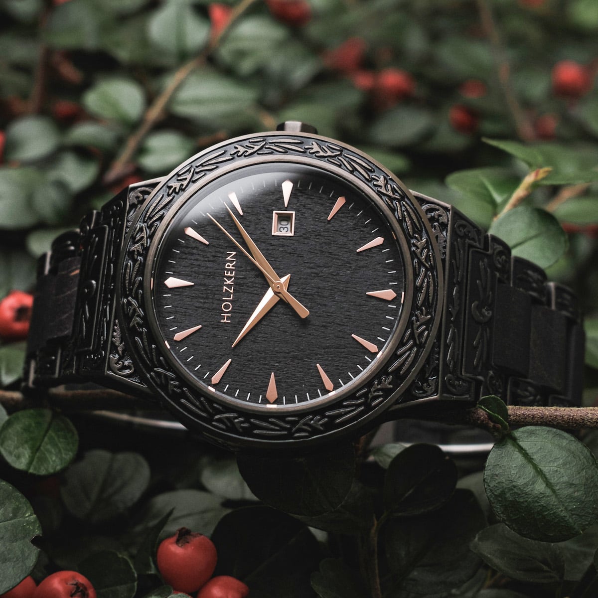 "Khalili" watch featuring a black engraved bezel and sleek hands, set against a natural backdrop.