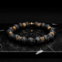 "Superset" bracelet, featuring a lava rock and gold bead design with a bold, textured style.