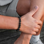 "Superset" bracelet in a lava and gold finish, worn on the wrist against a casual background.