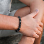 "Superset" bracelet featuring lava stone beads, showcasing a minimalist and rugged style.