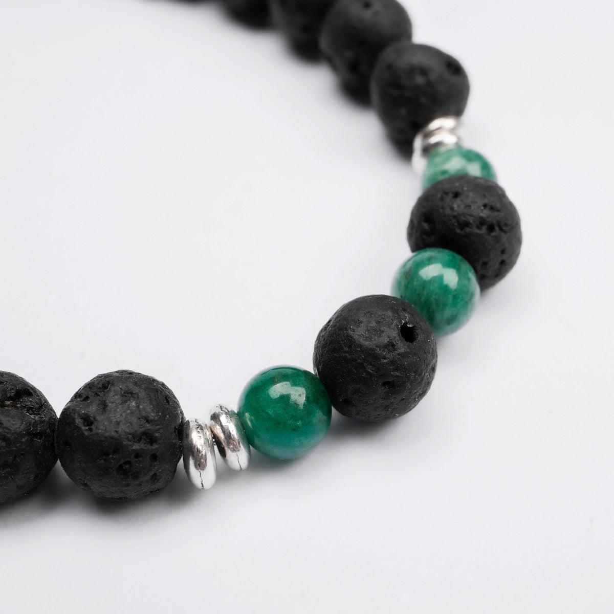 "Superset" bracelet featuring black lava and green marble beads with a sleek, modern style.