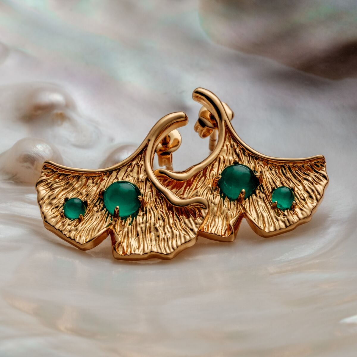 "Chalice Earrings" earrings feature a gold finish with chalcedony details, showcasing an elegant, textured leaf design.