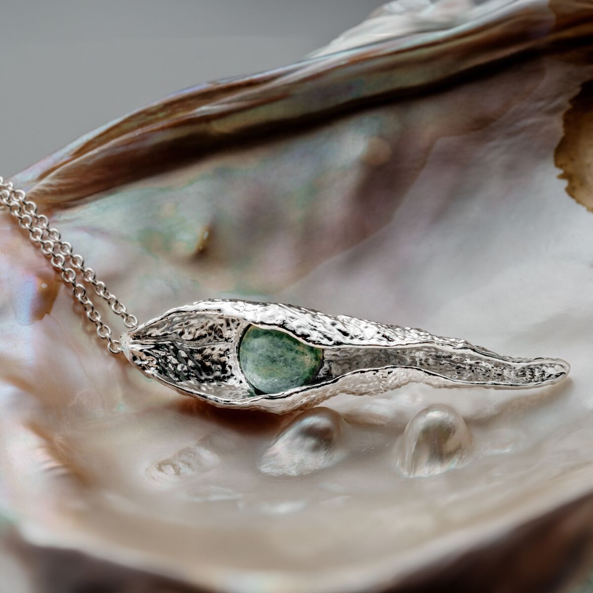 "Chalice Necklace": Elegant silver chalice necklace featuring amazonite, styled with a textured, organic design.