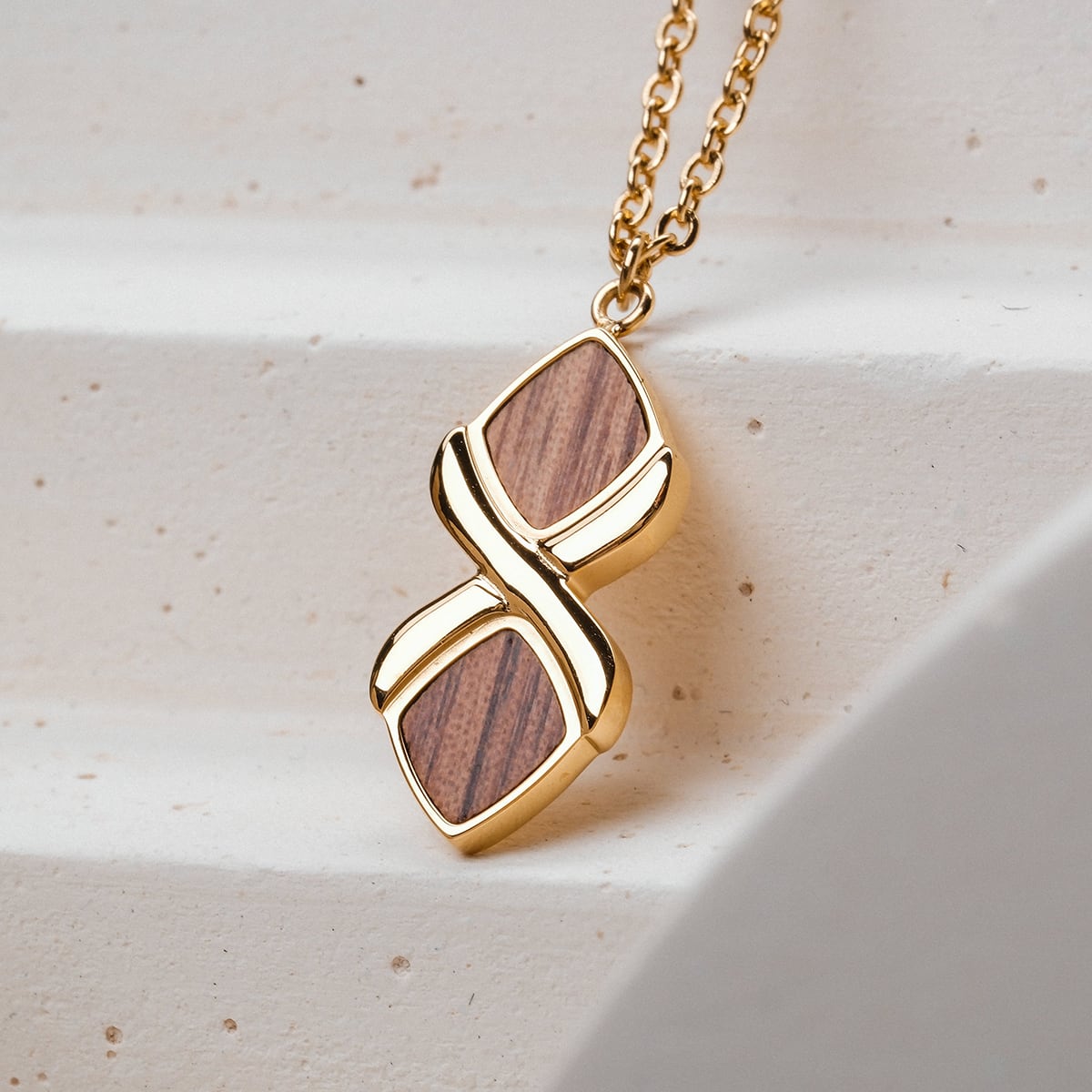 "Mosaic Necklace" necklace with a walnut and gold mosaic design, featuring an elegant dual-pendant style.
