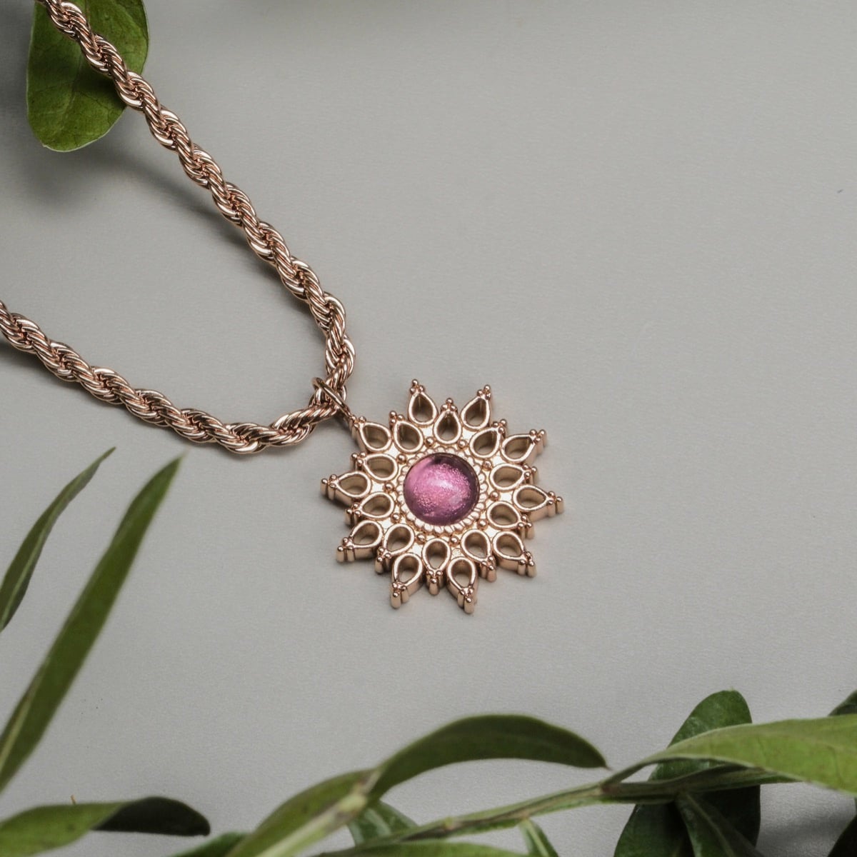 "Suncatcher Necklace" - a rose gold suncatcher necklace featuring amethyst with an intricate, elegant design.