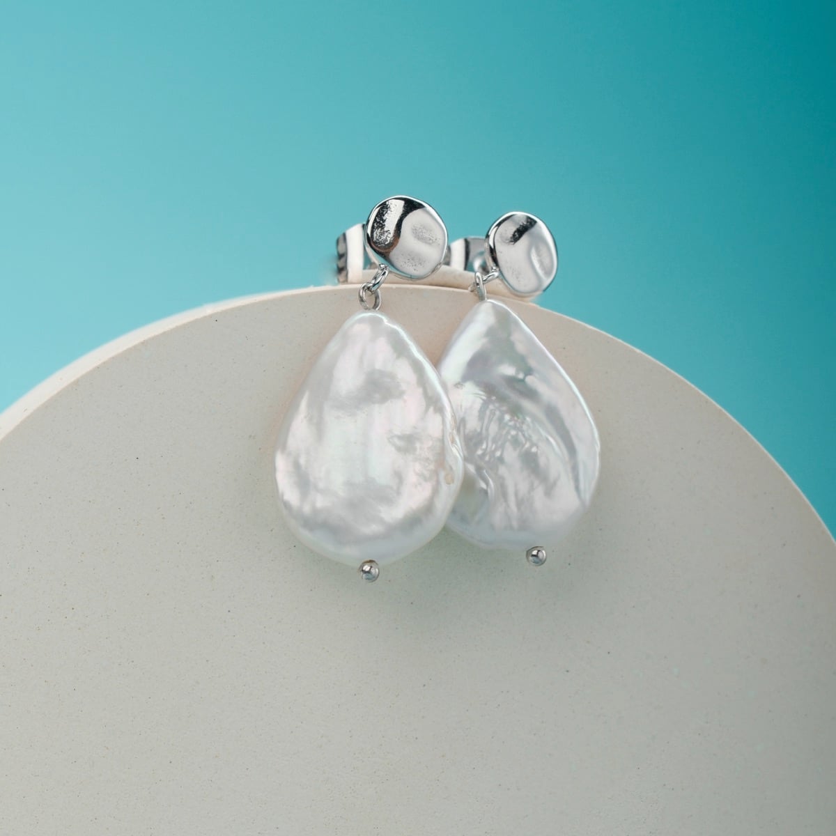 Summersweet Earrings: Baroque pearl and silver earrings with a sleek, elegant style.