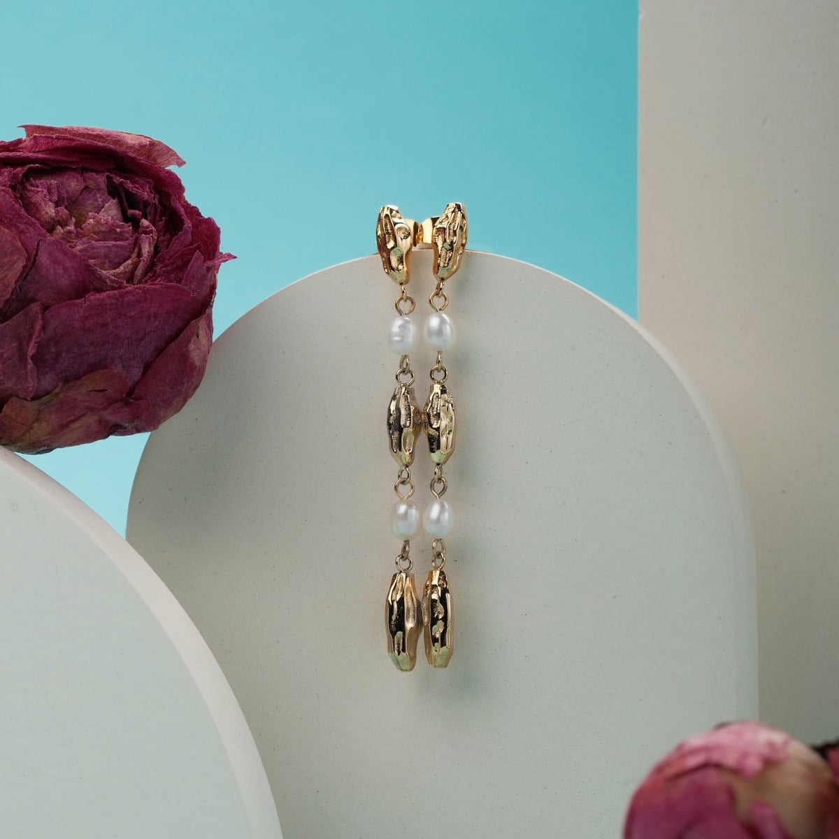 "Summersweet Earrings I" earrings featuring elegant pearl and gold design, set against a modern background.