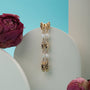 "Summersweet Earrings I" earrings featuring elegant pearl and gold design, set against a modern background.