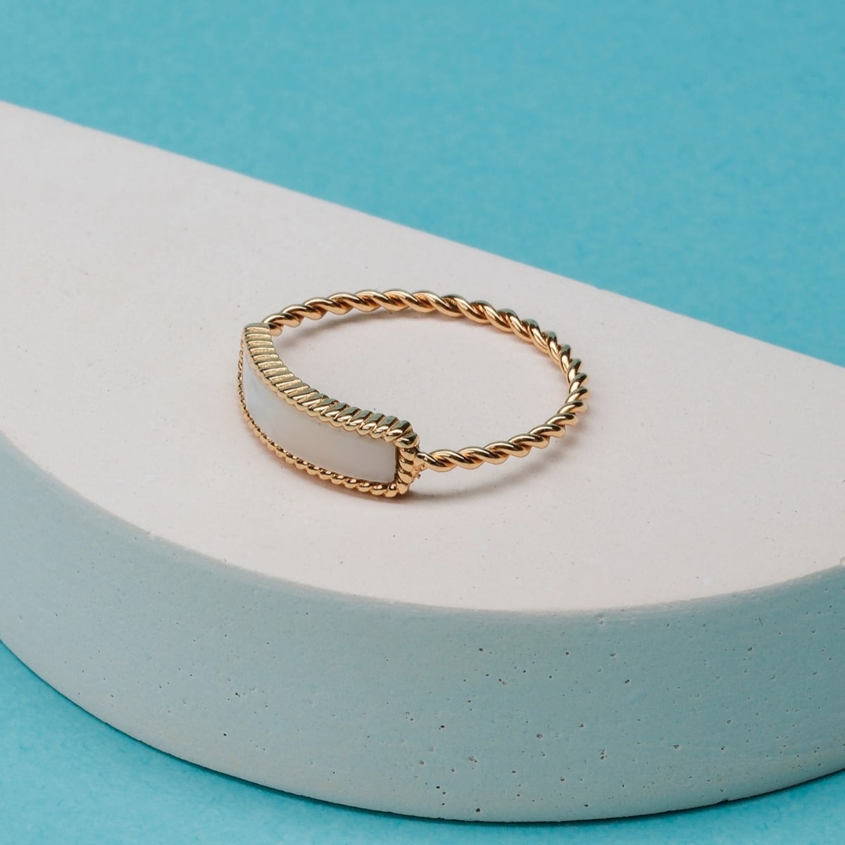 "Summersweet Ring", a gold and white nacre ring with an elegantly twisted rope band.