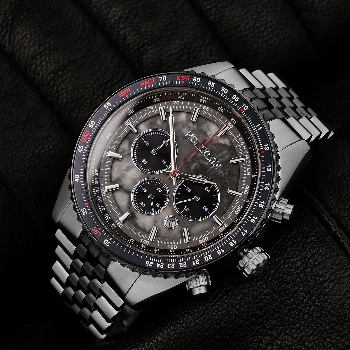 "Openhorizon" watch featuring a gray marble dial and silver accents, set on a sleek metal bracelet.