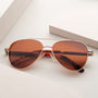 "The Badass II" sunglasses feature a walnut frame and matte gold details for a stylish and sophisticated look.