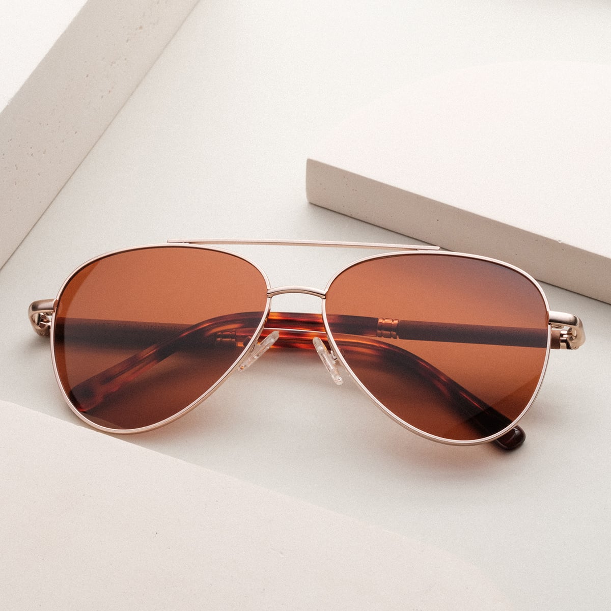 "The Badass II" sunglasses feature a walnut frame and matte gold details for a stylish and sophisticated look.