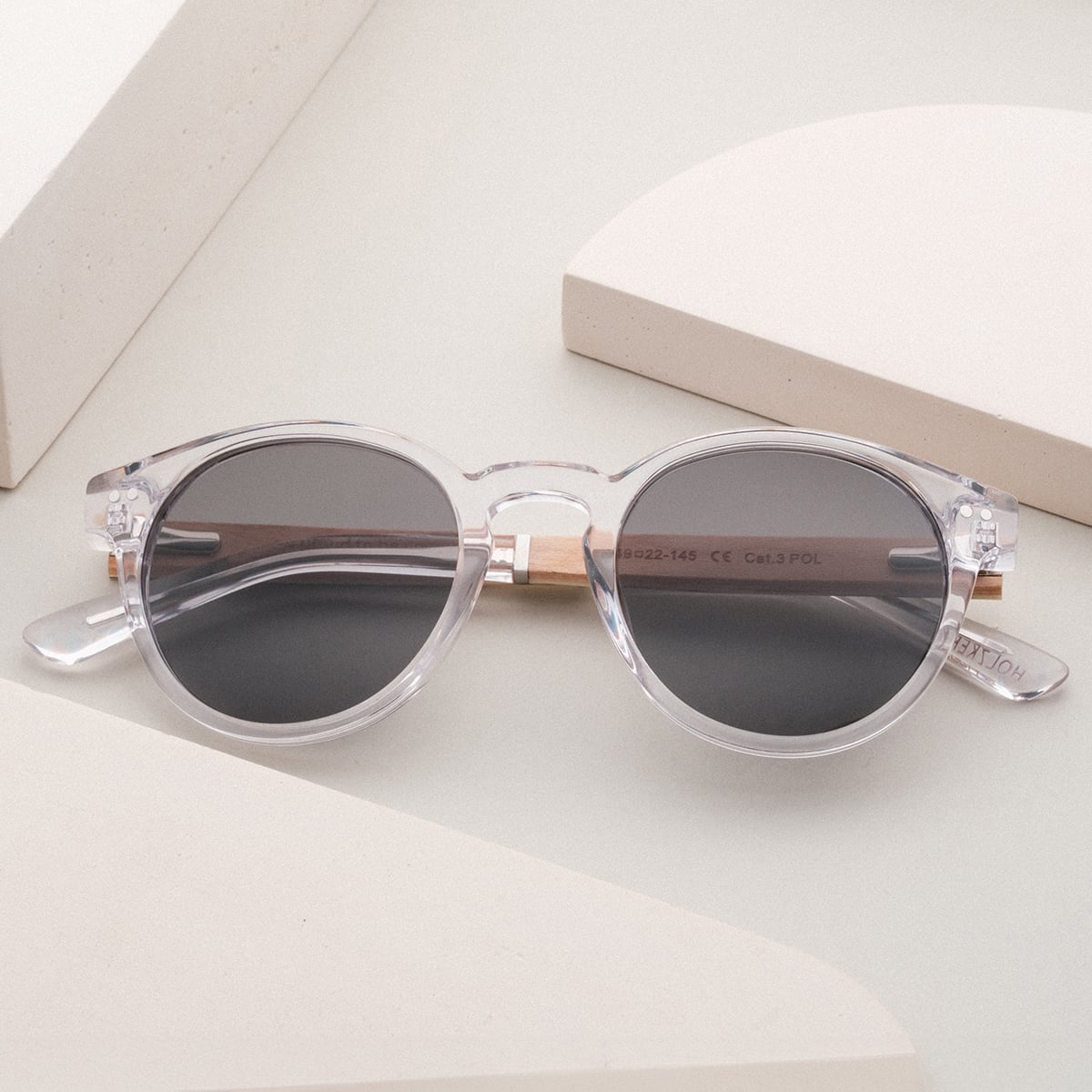 "The Hyped" sunglasses feature a sleek crystal frame with zebrawood accents for a modern look.