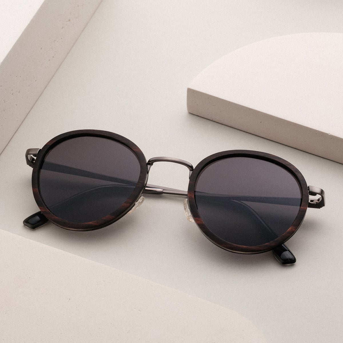 "The Radiant M" sunglasses featuring a stylish leadwood frame and antique silver accents.