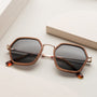 "The Sincere" sunglasses feature a walnut and matte gold geometric frame for a stylish look.