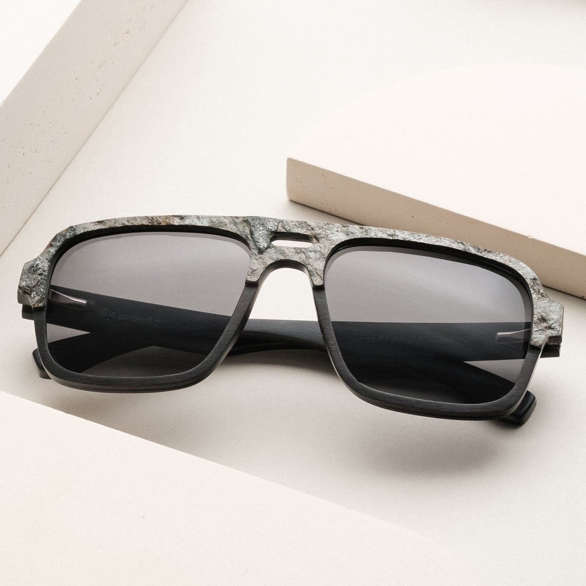 "The Triumphant" sunglasses with a modern design in sleek maple and slate finish, offering a contemporary visual style.