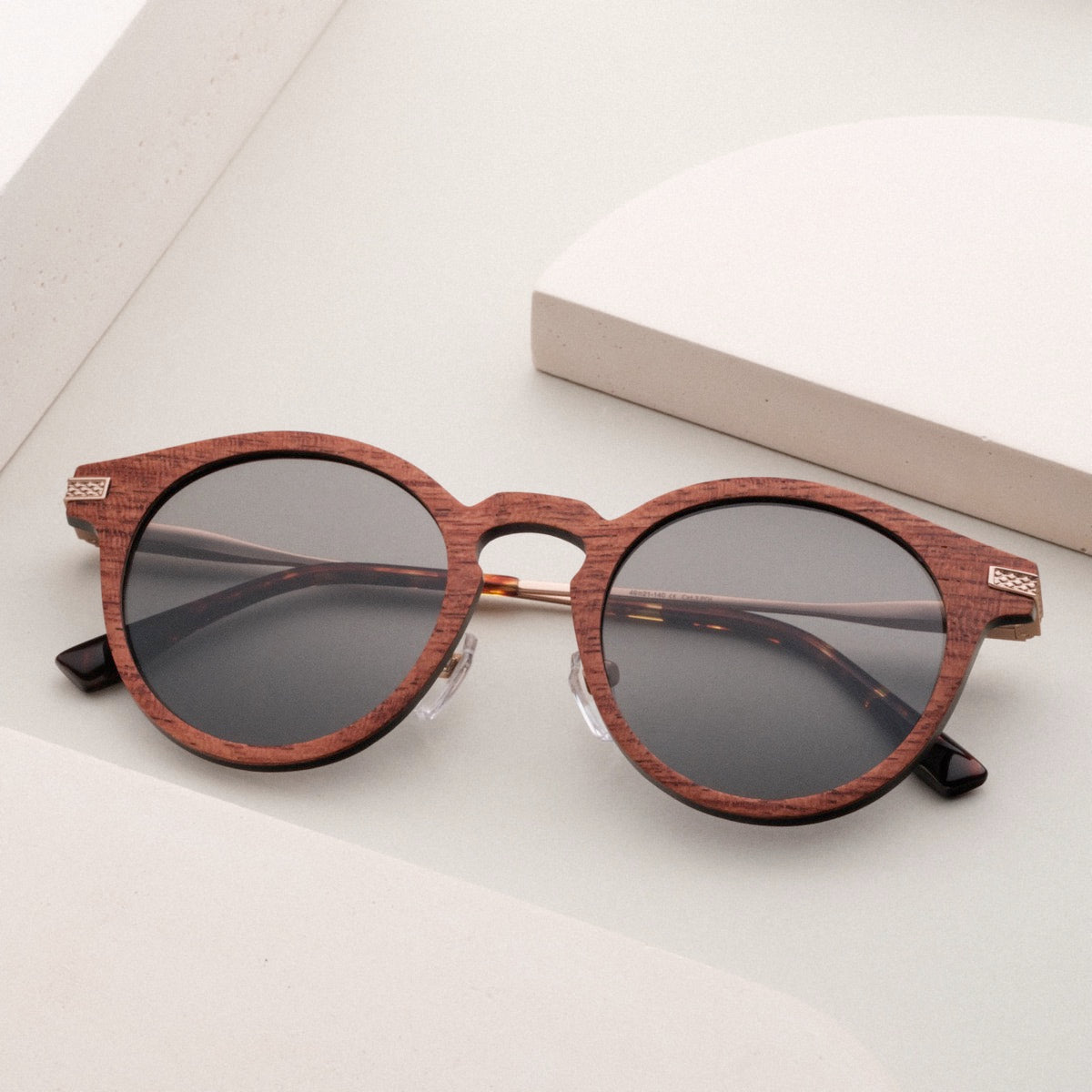 "The Maverick" sunglasses feature a stylish Padouk wood and Copper design with a sleek, modern aesthetic.