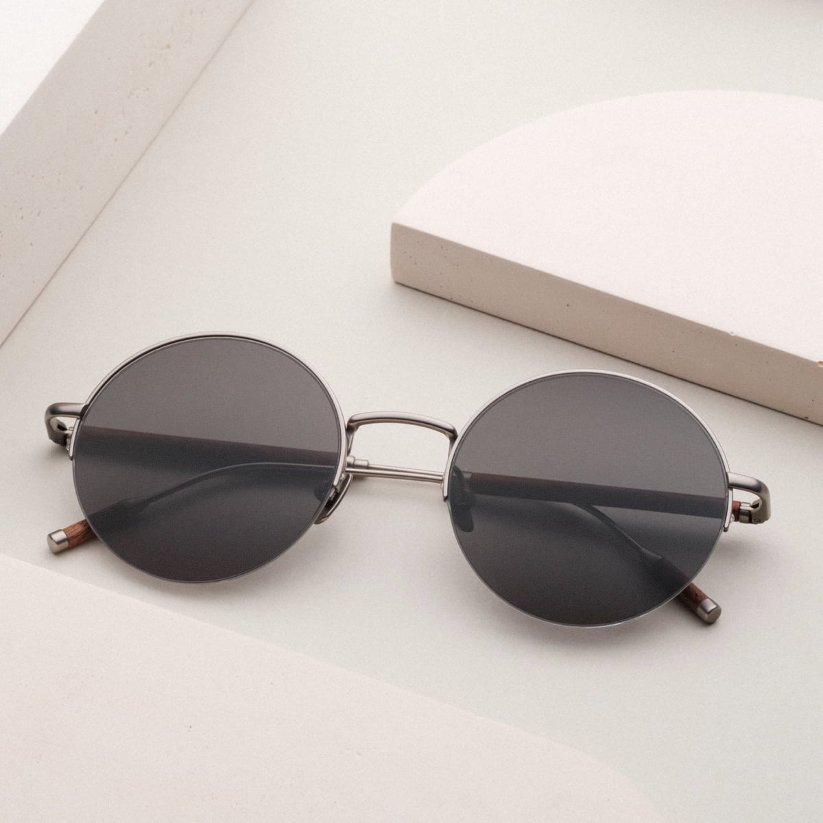 "The Adventurous" sunglasses with walnut accents and dark gray lenses, featuring a sleek, modern design.