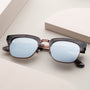 "The Virtuoso" sunglasses with a sleek, modern design, featuring a combination of Leadwood and Ash materials.